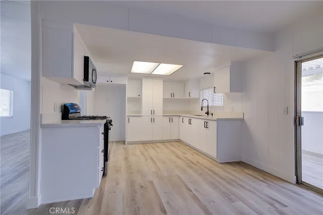 a kitchen with a sink and a stove top oven