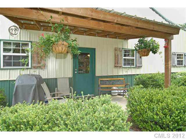 1139 State Rd S-46-27 Clover, SC 29710 - Photo 2 of 16 a view of a house with a large windows and plants