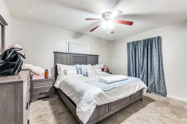 a bedroom with bed and a chandelier