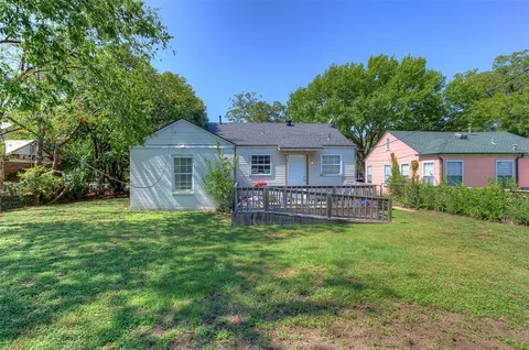 a view of a house with a yard and sitting area