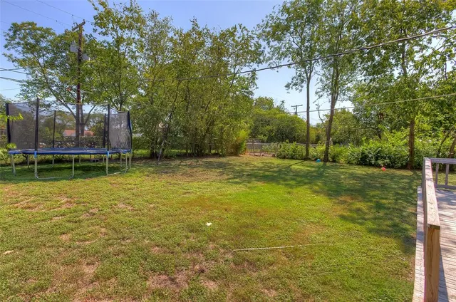 a view of a swimming pool with a house in the background