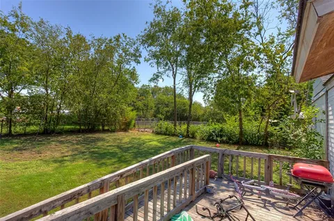 a view of a wooden deck with lake view