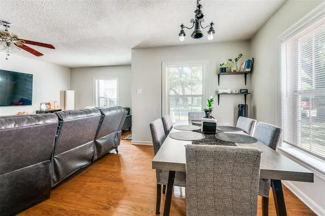 a living room with furniture kitchen view and a window