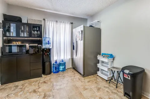a view of a refrigerator and storage in a room