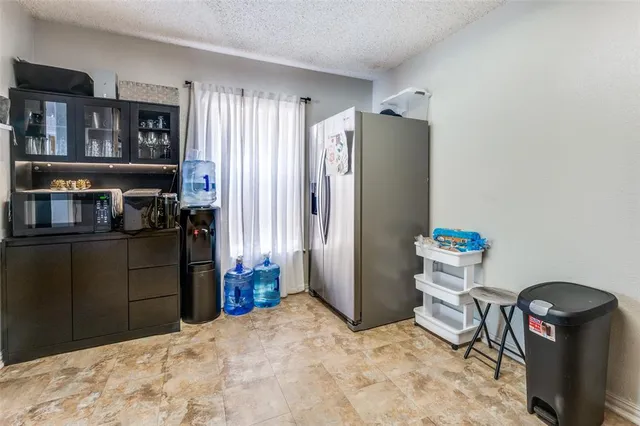 a view of a refrigerator and storage in a room