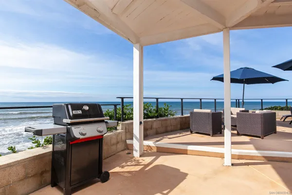 a view of an outdoor space with furniture and umbrella