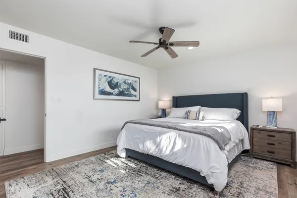 a bedroom with a bed and a mirror