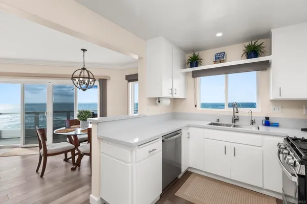 a kitchen with stainless steel appliances granite countertop white cabinets a sink and dishwasher