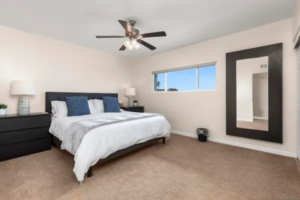 a bedroom with a bed and a lamp