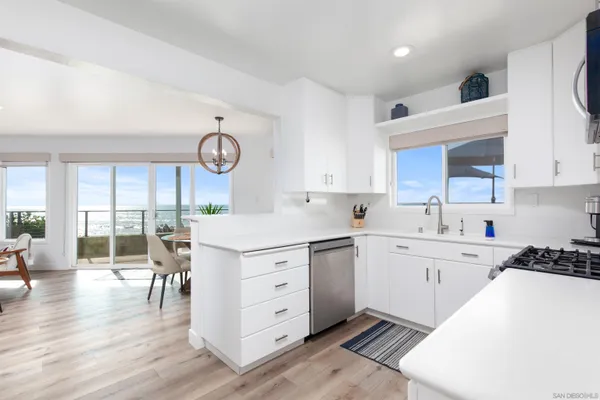 a kitchen with stainless steel appliances a sink stove and cabinets