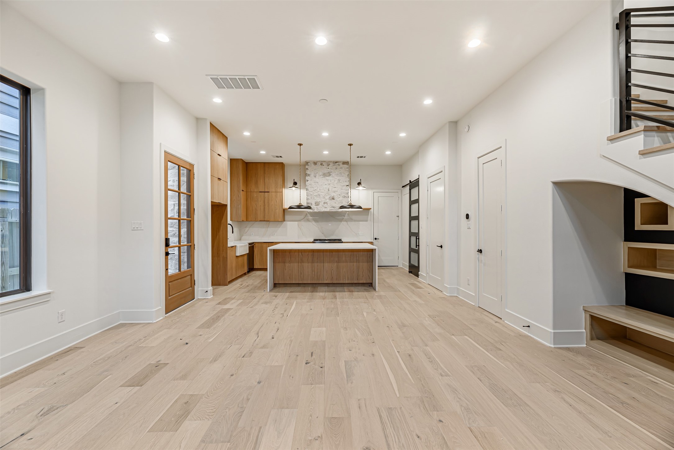 1104 West 9th Street Houston, TX 77007 - Photo 4 of 25 a view of a kitchen with kitchen island wooden floor and stainless steel appliances