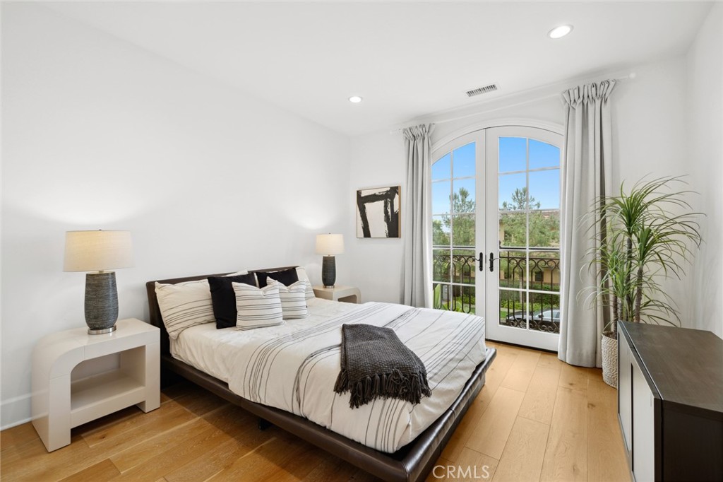 115 Treasure Irvine, CA 92602 - Photo 21 of 39 a bedroom with a large bed and a large window