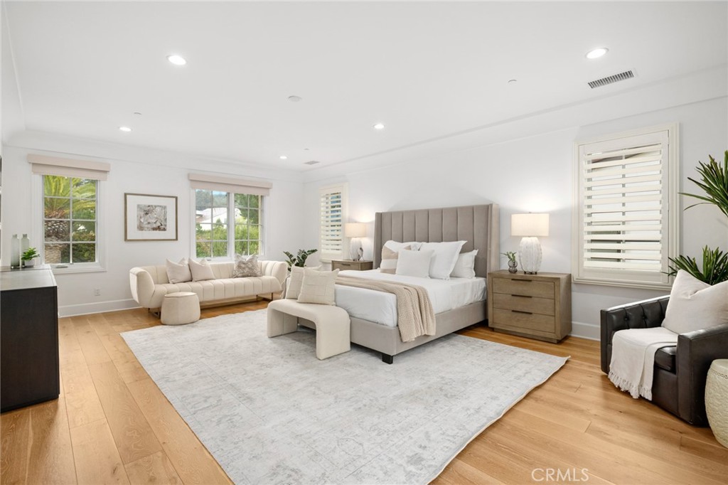 115 Treasure Irvine, CA 92602 - Photo 27 of 39 a spacious bedroom with a large bed and a couch