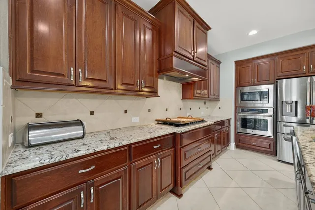 a kitchen with stainless steel appliances granite countertop wooden cabinets a sink and dishwasher