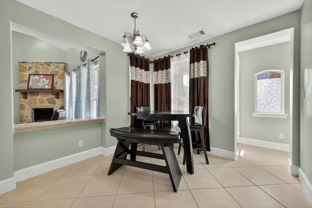 a kitchen with stainless steel appliances granite countertop a sink a stove and a wooden cabinets