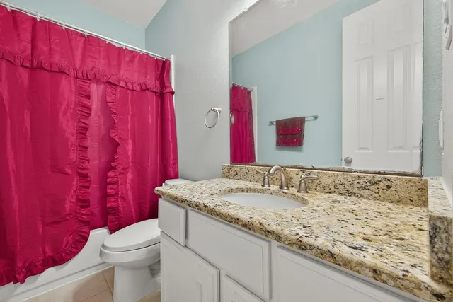 a bedroom with a bed and a chair