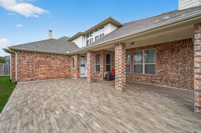 a bathroom with a granite countertop sink and white cabinets