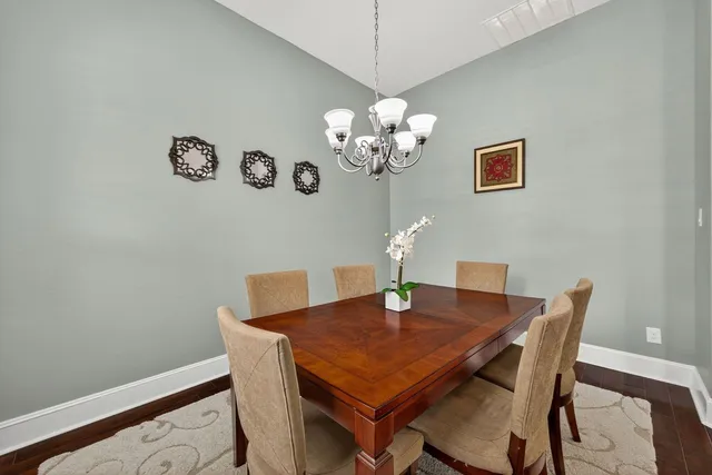 a view of a dining room with a table and chairs