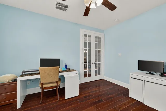 a workspace with furniture wooden floor and a window