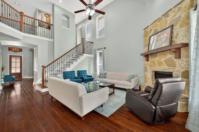 a living room with furniture a fireplace and a large window