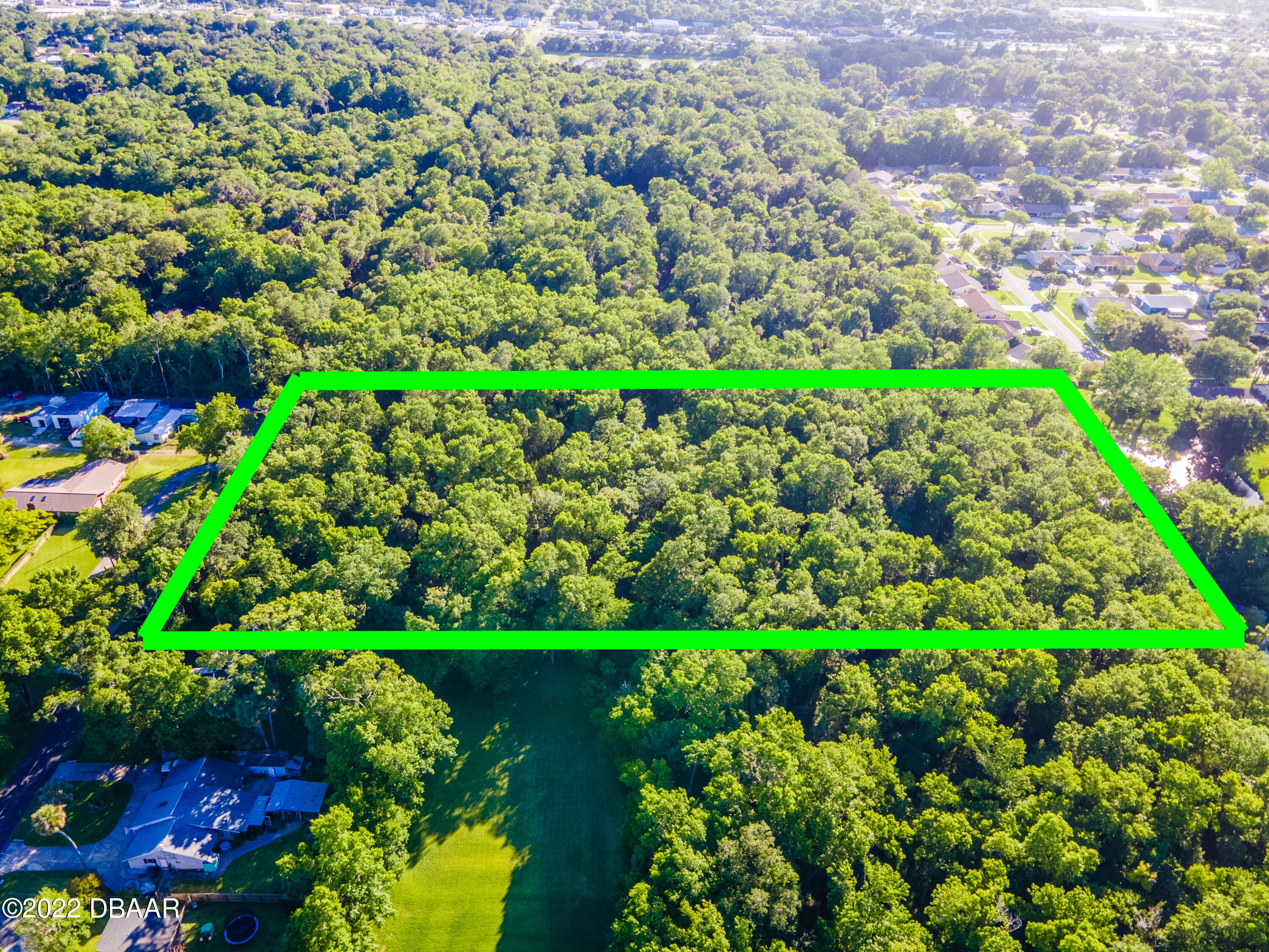 845 Arroyo Parkway Ormond Beach, FL 32174 - Photo 4 of 8 a view of a garden with a lot of flowers and trees