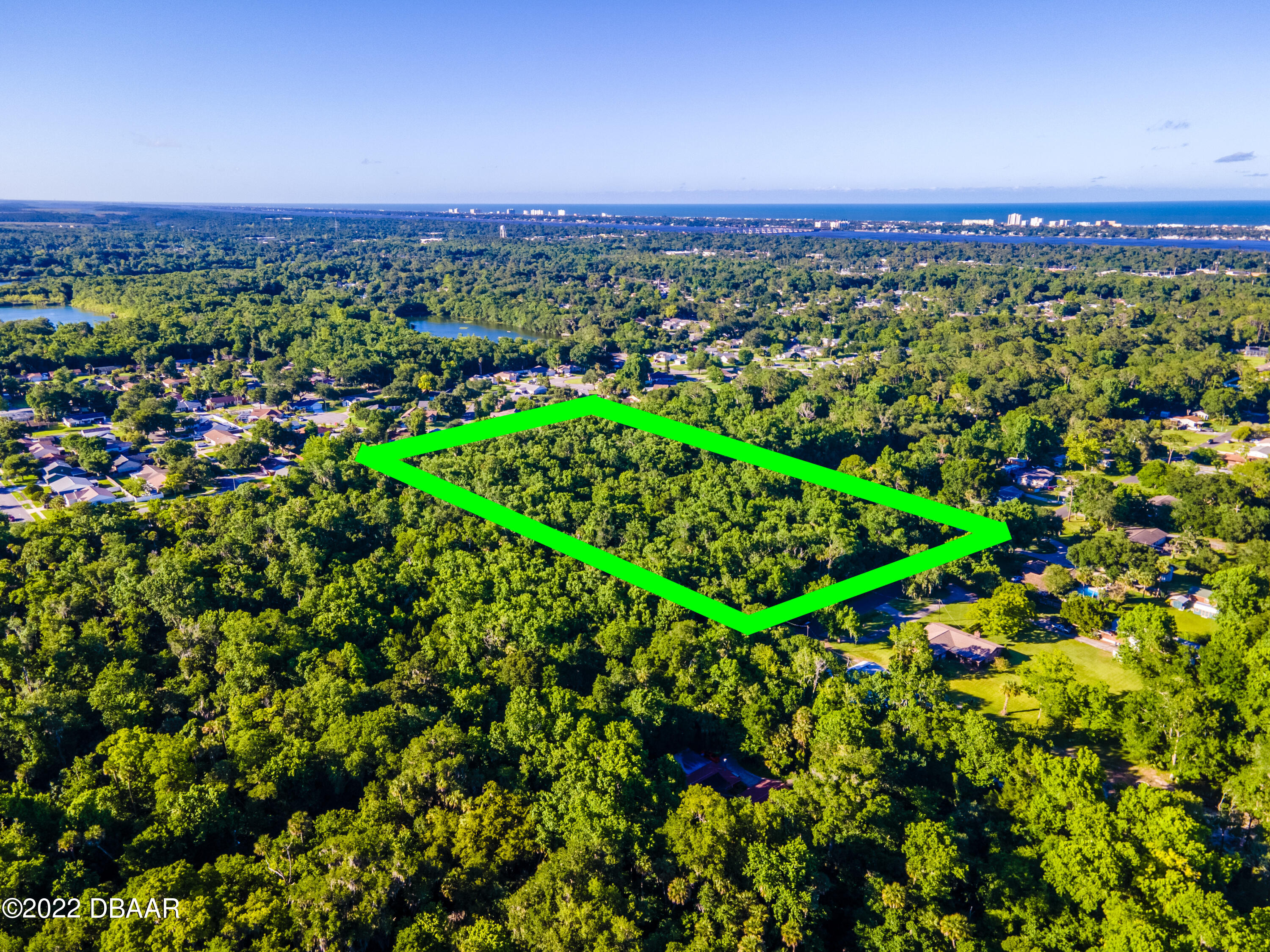 845 Arroyo Parkway Ormond Beach, FL 32174 - Photo 7 of 8 a view of a city with lush green forest