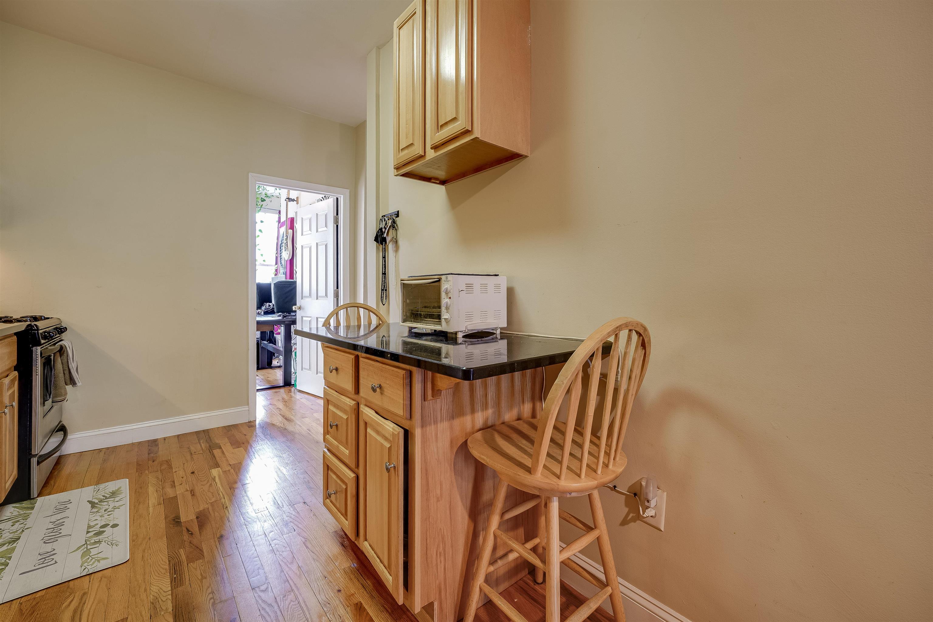 63 Madison Street, Unit 3 Hoboken, NJ 07030 - Photo 12 of 19 a view of a workspace with furniture and wooden floor
