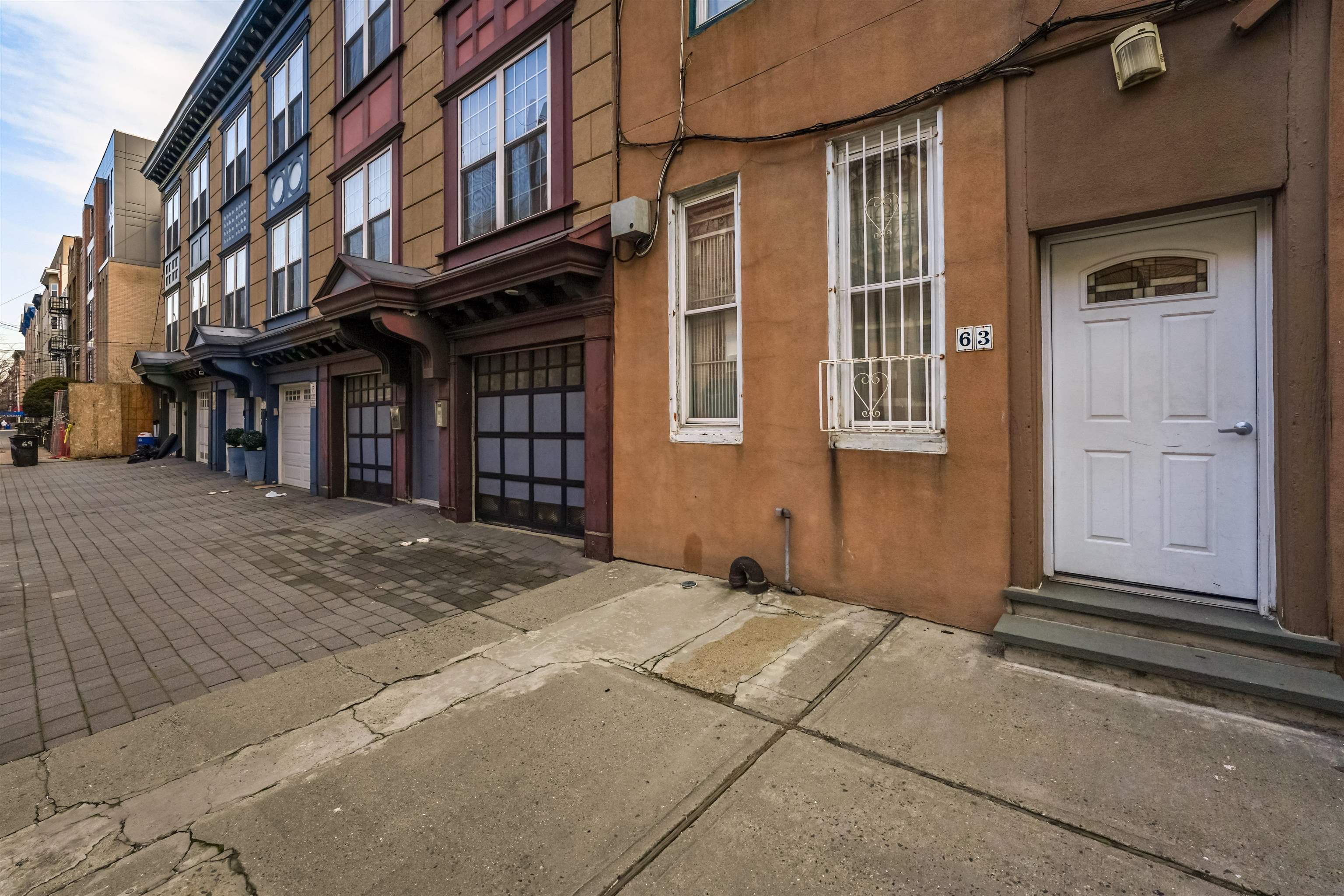 63 Madison Street, Unit 3 Hoboken, NJ 07030 - Photo 18 of 19 a view of a brick building with many windows
