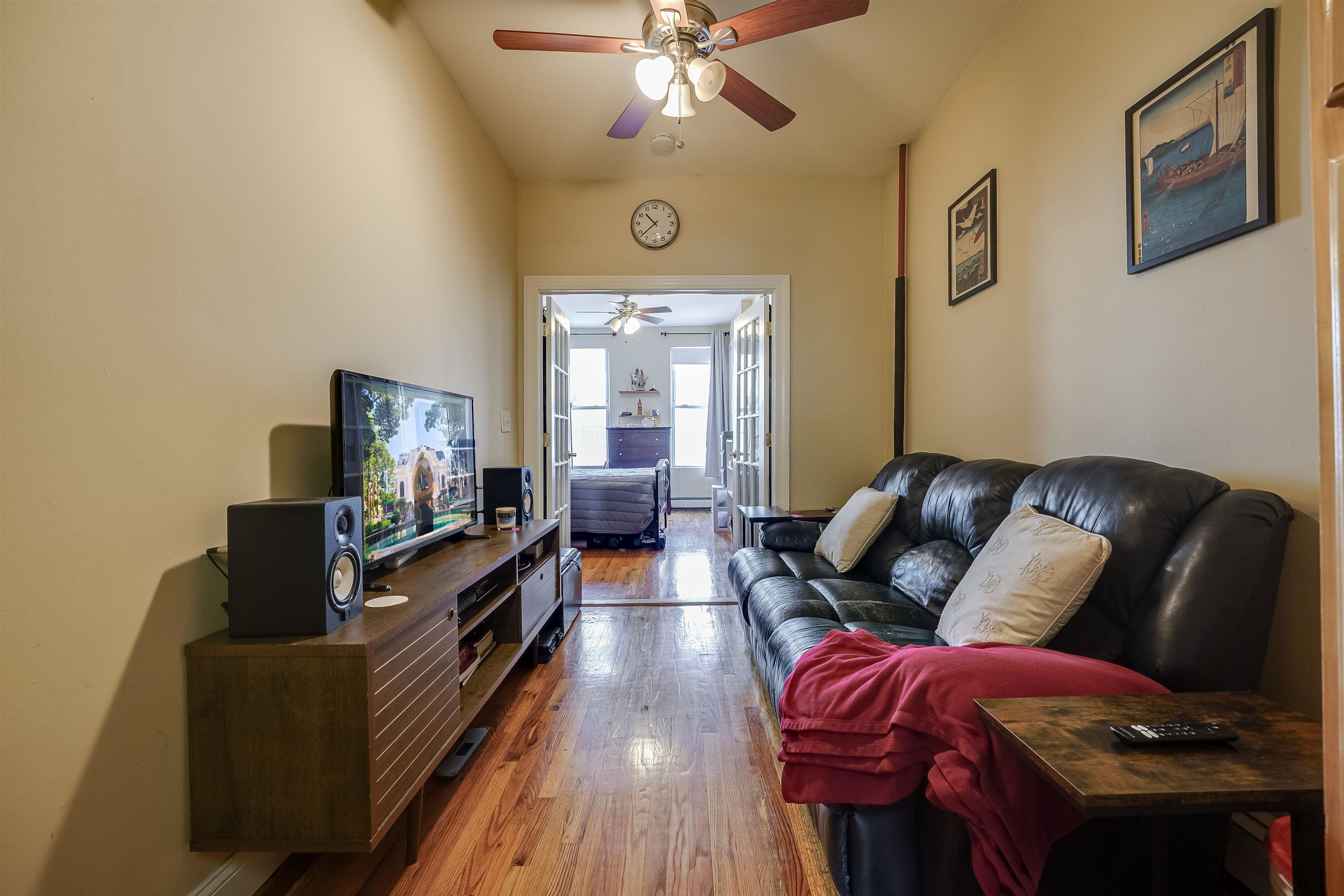 63 Madison Street, Unit 3 Hoboken, NJ 07030 - Photo 2 of 19 a living room with furniture and a flat screen tv