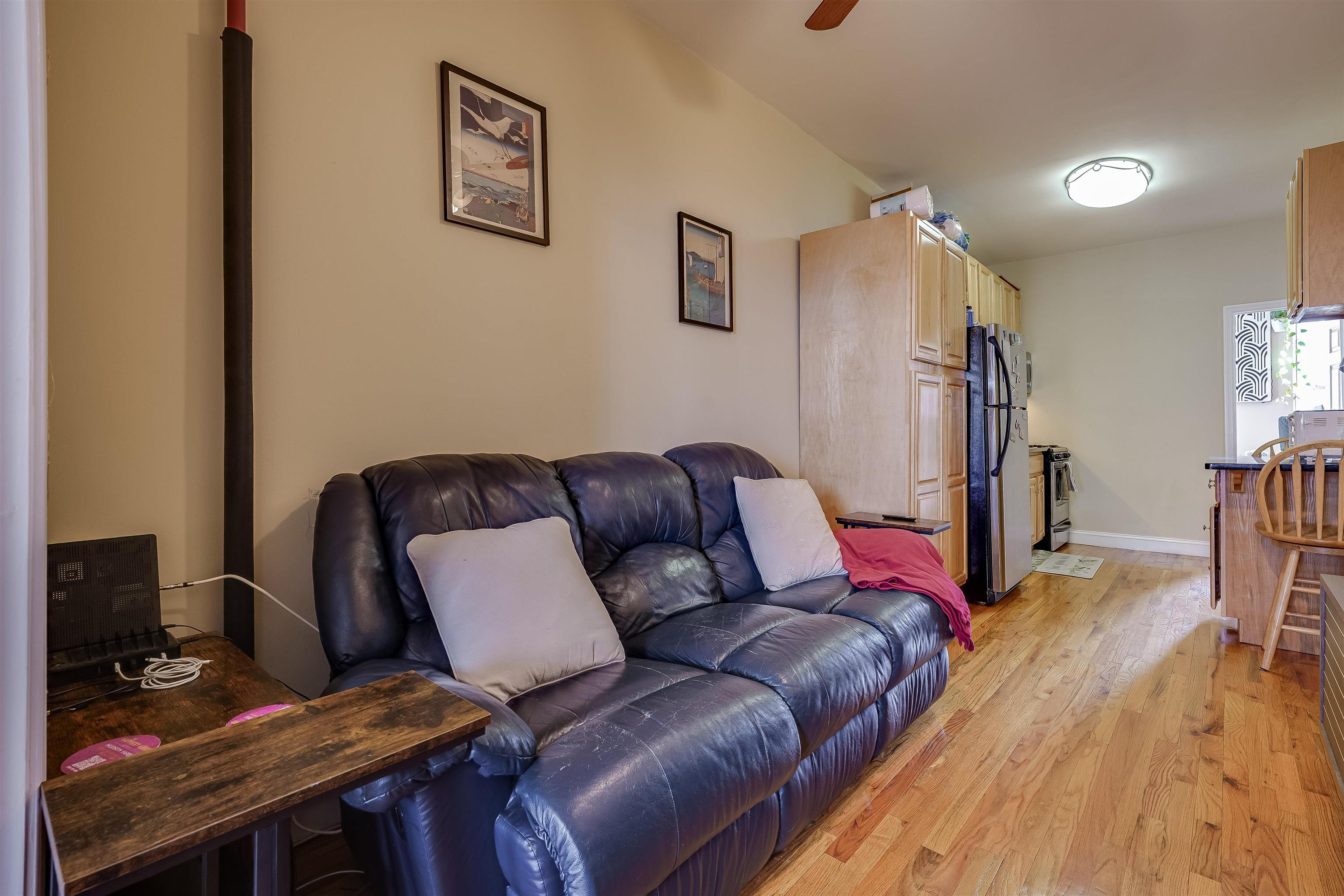 63 Madison Street, Unit 3 Hoboken, NJ 07030 - Photo 4 of 19 a living room with furniture and a wooden floor