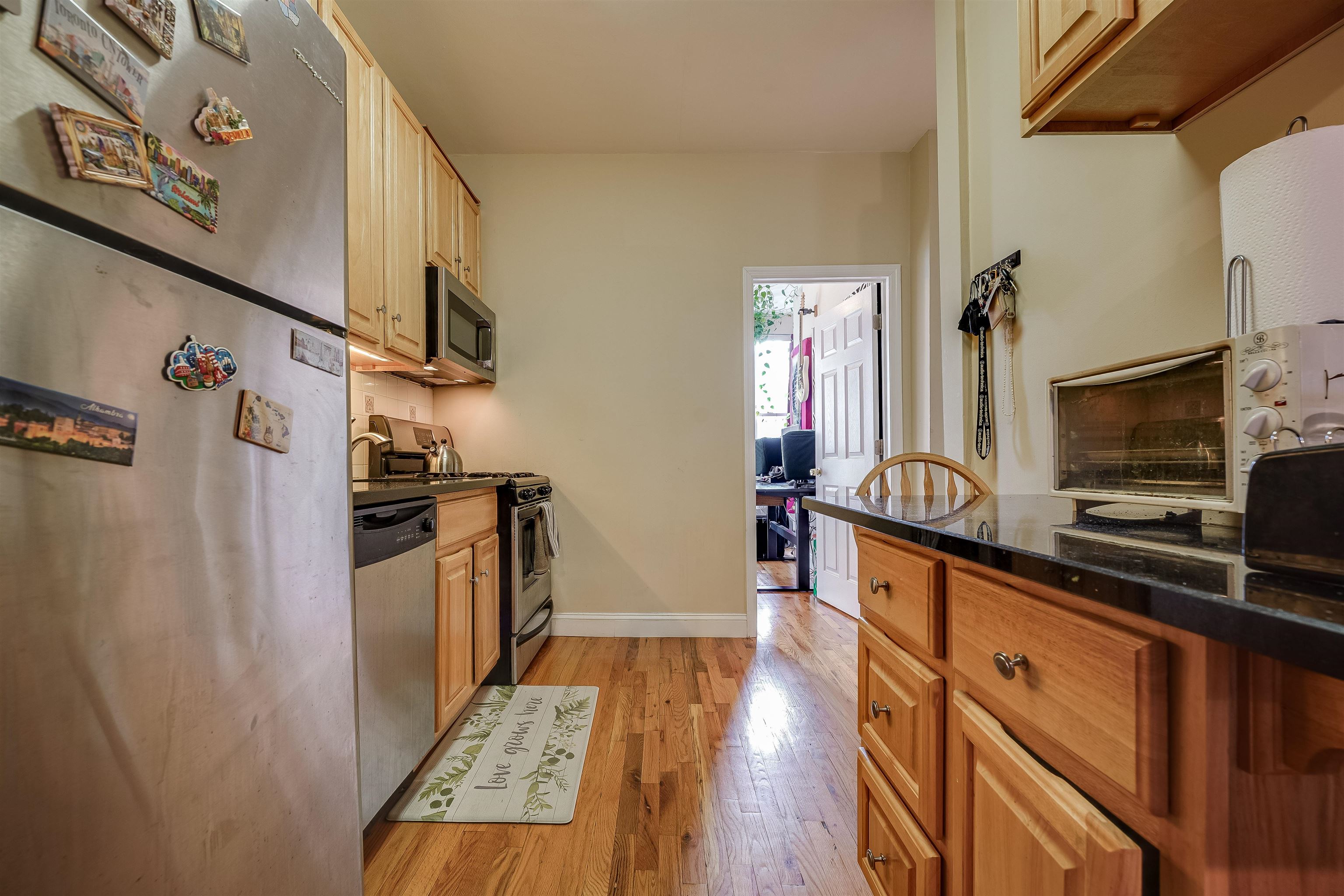 63 Madison Street, Unit 3 Hoboken, NJ 07030 - Photo 10 of 19 a kitchen with stainless steel appliances a refrigerator and a stove top oven