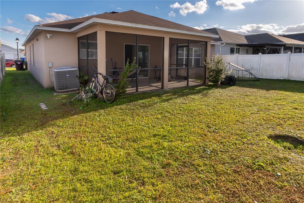 4563 Orchard Grove Road St. Cloud, FL 34772 - Photo 9 of 51 a front view of a house with garden
