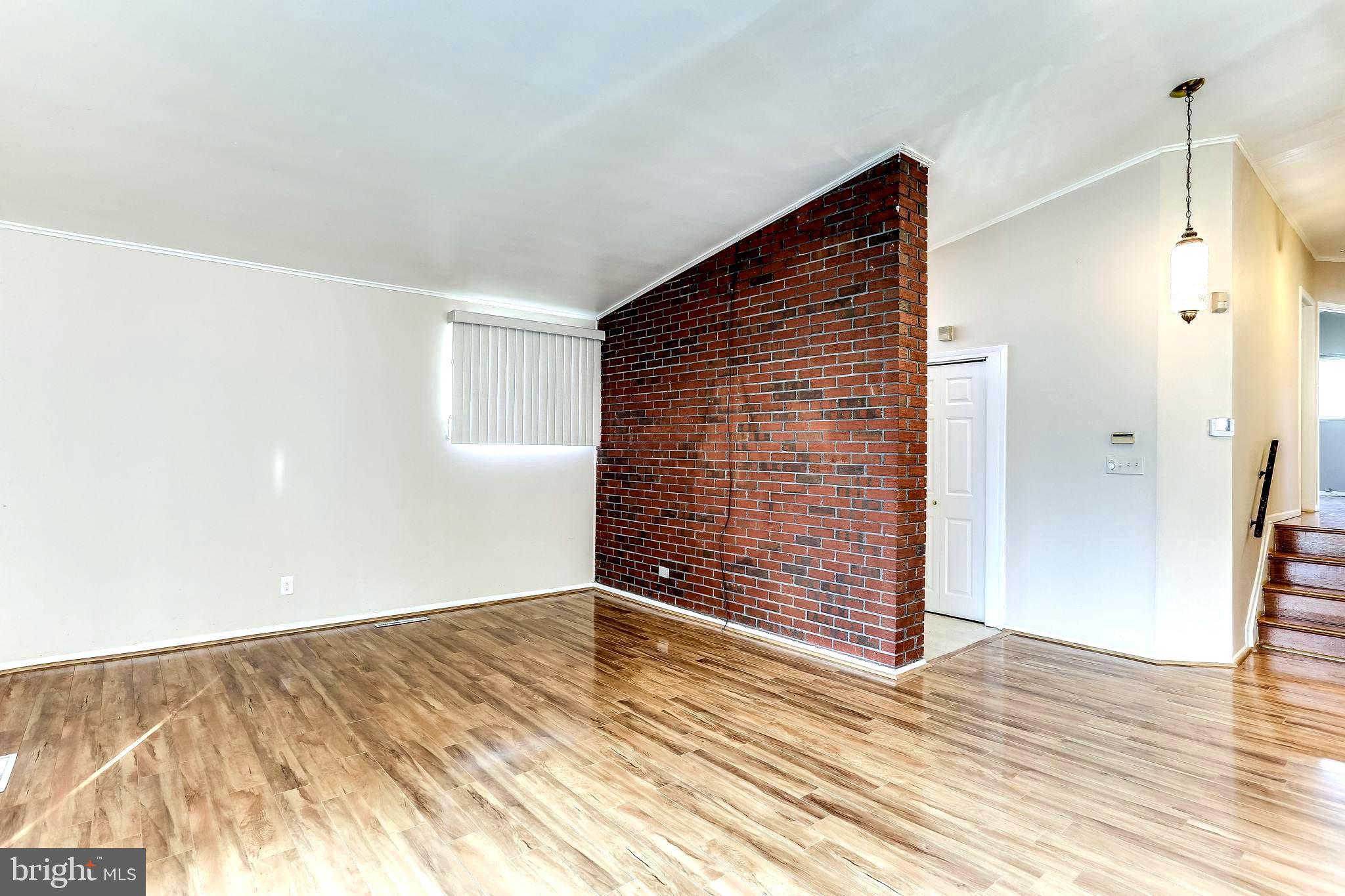 4729 Belle Forte Road Baltimore, MD 21208 - Photo 14 of 46 Living Room with Brick Wall
