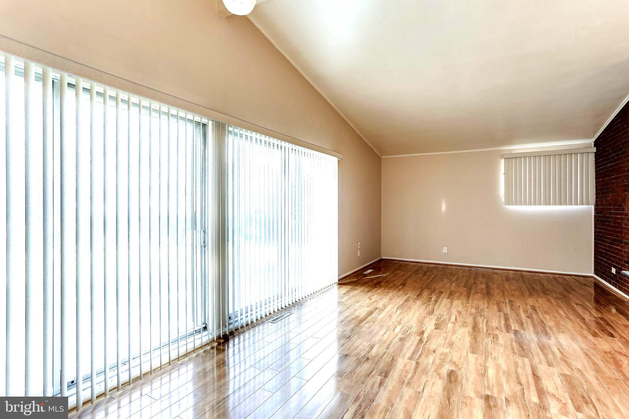 4729 Belle Forte Road Baltimore, MD 21208 - Photo 15 of 46 Living Room / Dining Room with Sliding Glass Doors