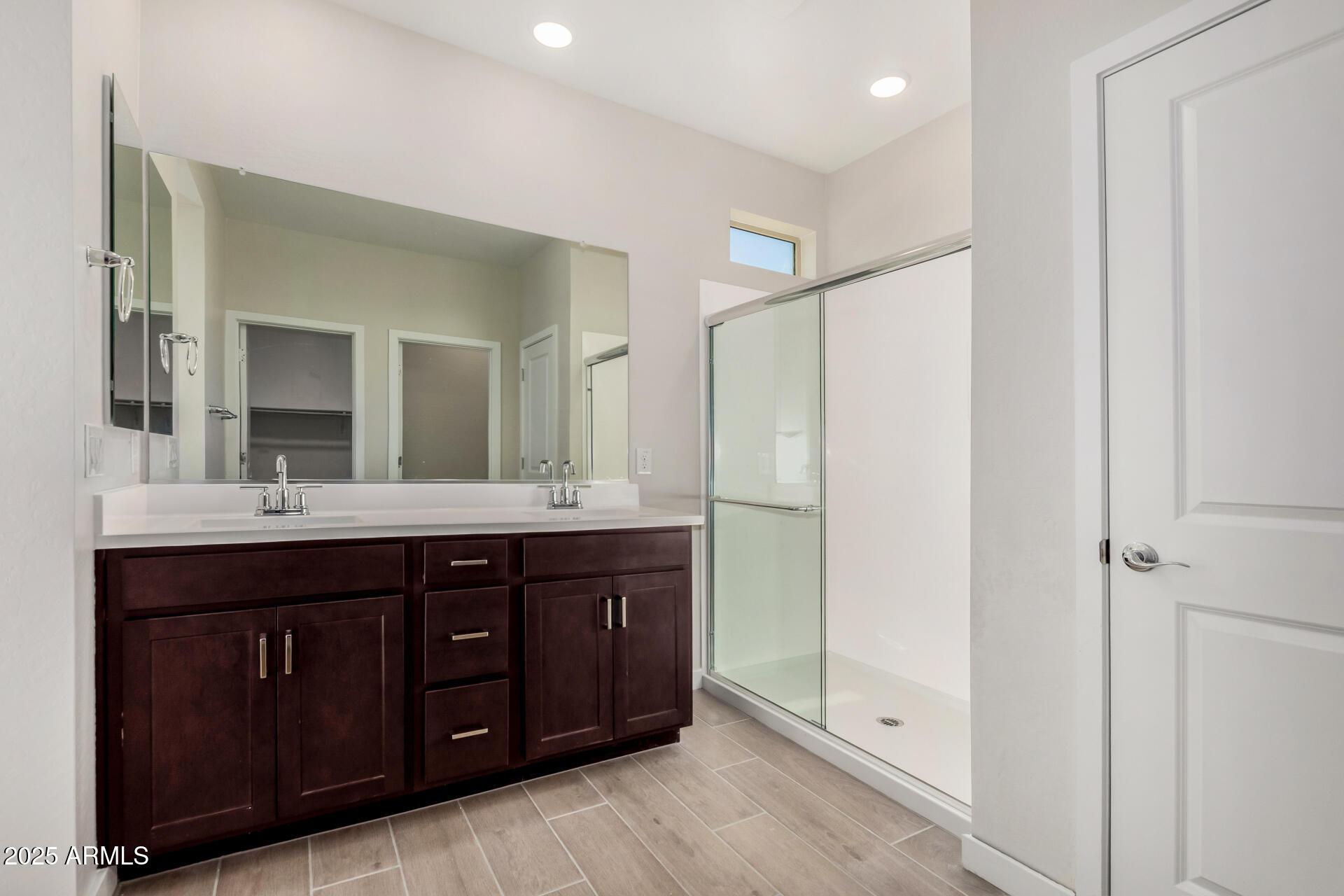 16977 West Spur Drive Surprise, AZ 85387 - Photo 16 of 30 a bathroom with a double vanity sink and mirror