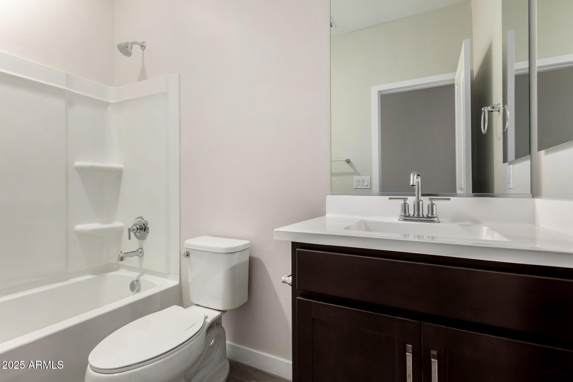 16977 West Spur Drive Surprise, AZ 85387 - Photo 22 of 30 a bathroom with a granite countertop toilet sink and a bathtub