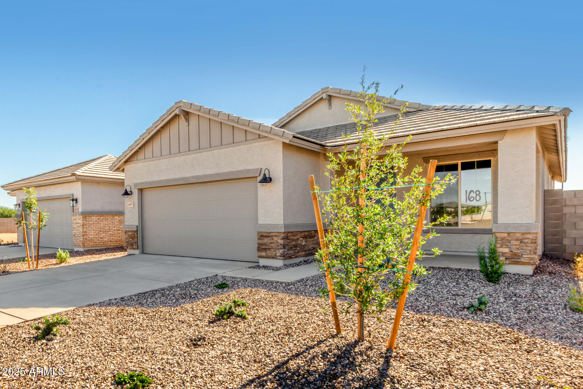 16977 West Spur Drive Surprise, AZ 85387 - Photo 3 of 30 a view of a house with a small yard and large window