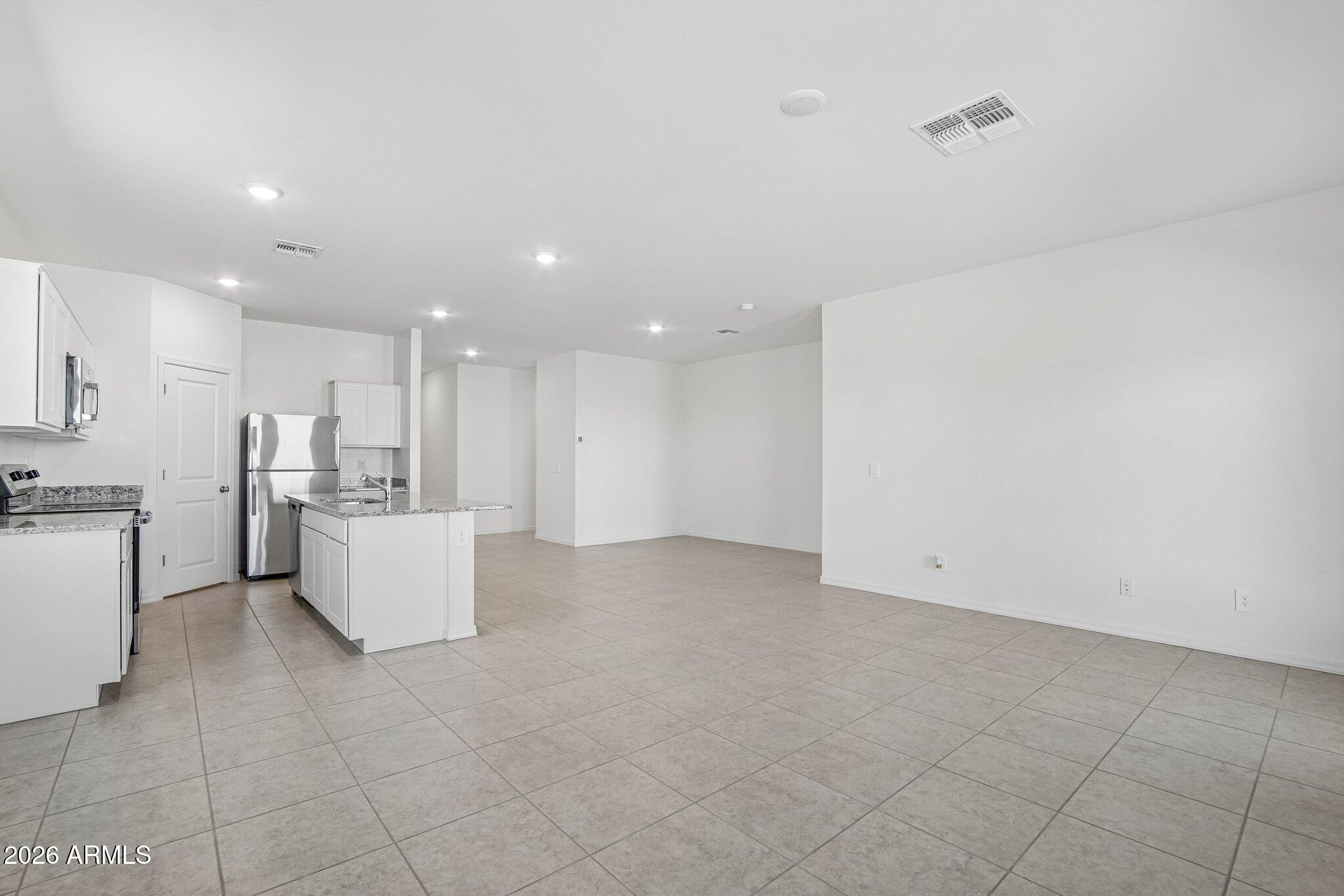47235 West Old Timer Road Maricopa, AZ 85139 - Photo 3 of 23 SL_Moonbeam_Kitchen_Family_Room_B (3)