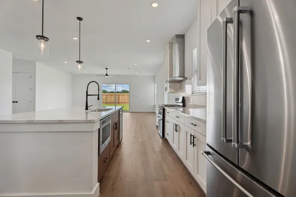 a kitchen with kitchen island granite countertop lots of counter top space and stainless steel appliances