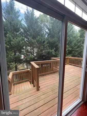 a view of a balcony with wooden floor
