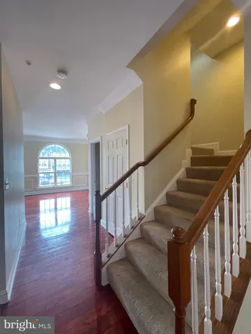 a view of entryway and hall with wooden floor