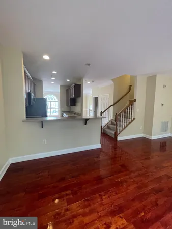 a view of kitchen and hall with wooden floor