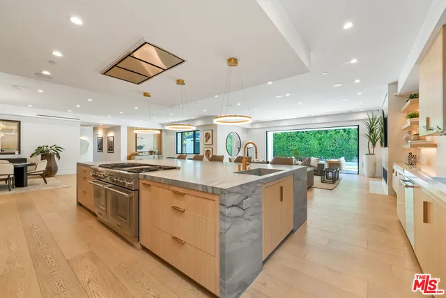 a large kitchen with stainless steel appliances granite countertop a large counter top and a stove