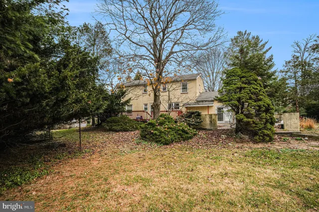 a view of backyard of house with green space