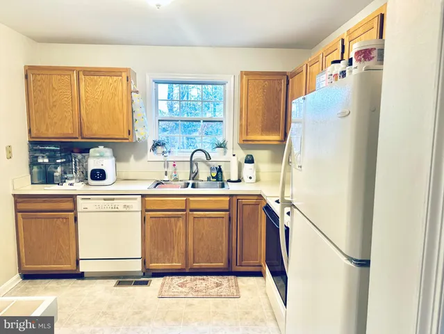 a kitchen with a refrigerator a sink and dishwasher