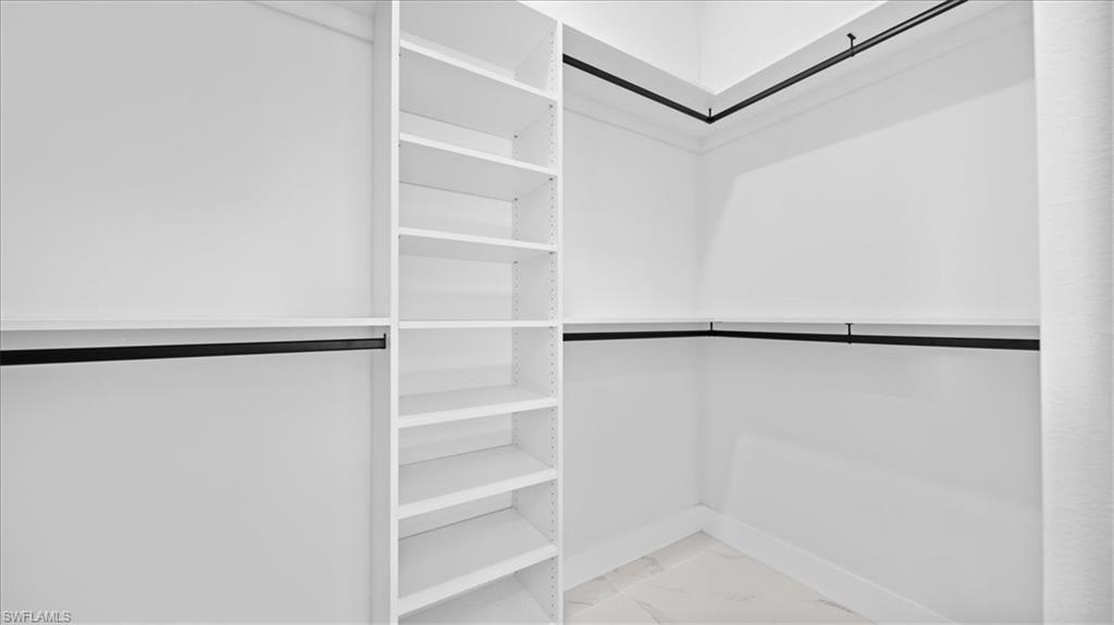 926 Winters Street East Lehigh Acres, FL 33974 - Photo 12 of 36 a view of walk in closet with empty racks