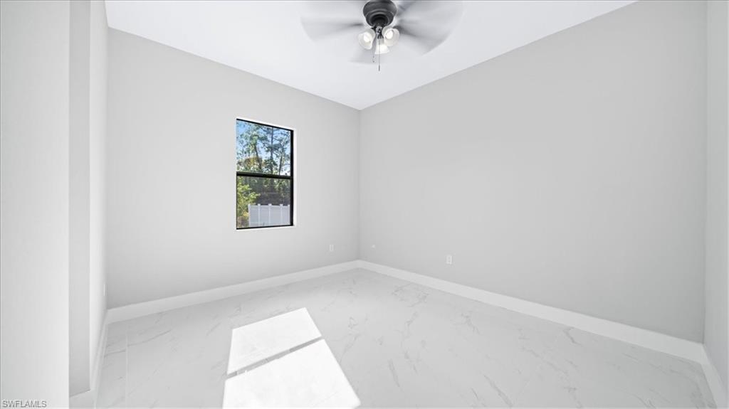 926 Winters Street East Lehigh Acres, FL 33974 - Photo 14 of 36 an empty room with a window