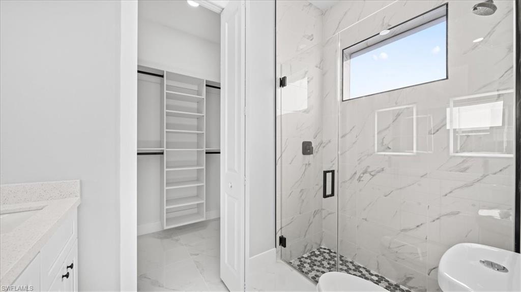 926 Winters Street East Lehigh Acres, FL 33974 - Photo 16 of 36 a bathroom with a shower toilet and sink