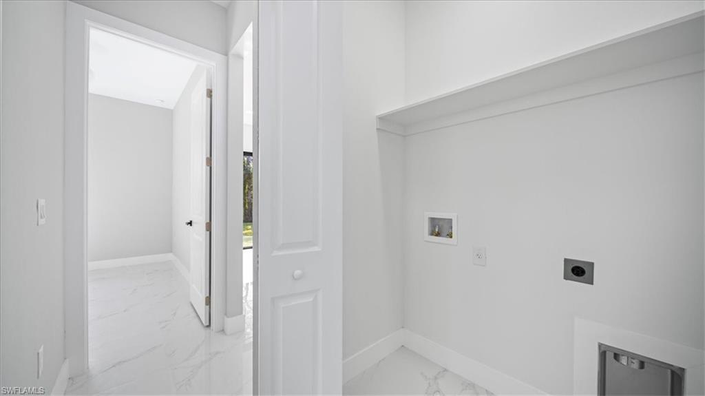 926 Winters Street East Lehigh Acres, FL 33974 - Photo 17 of 36 a bathroom with a bathtub