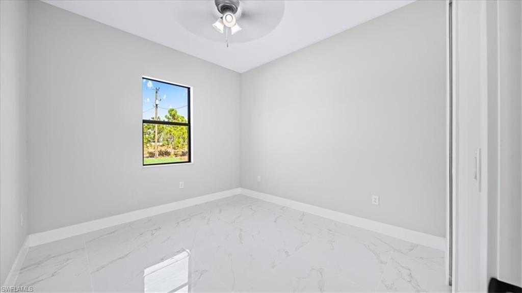 926 Winters Street East Lehigh Acres, FL 33974 - Photo 19 of 36 an empty room with a window